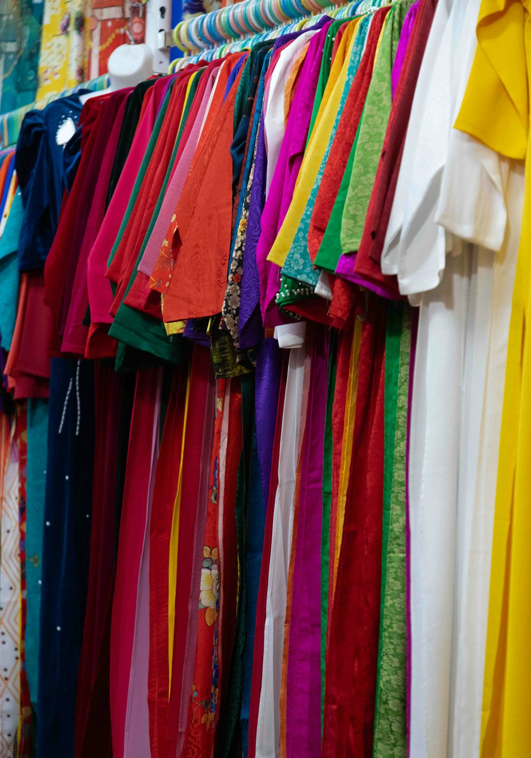 our-story colorful-dresses-hanging-on-a-rack-indoors-g1wavtyupmo